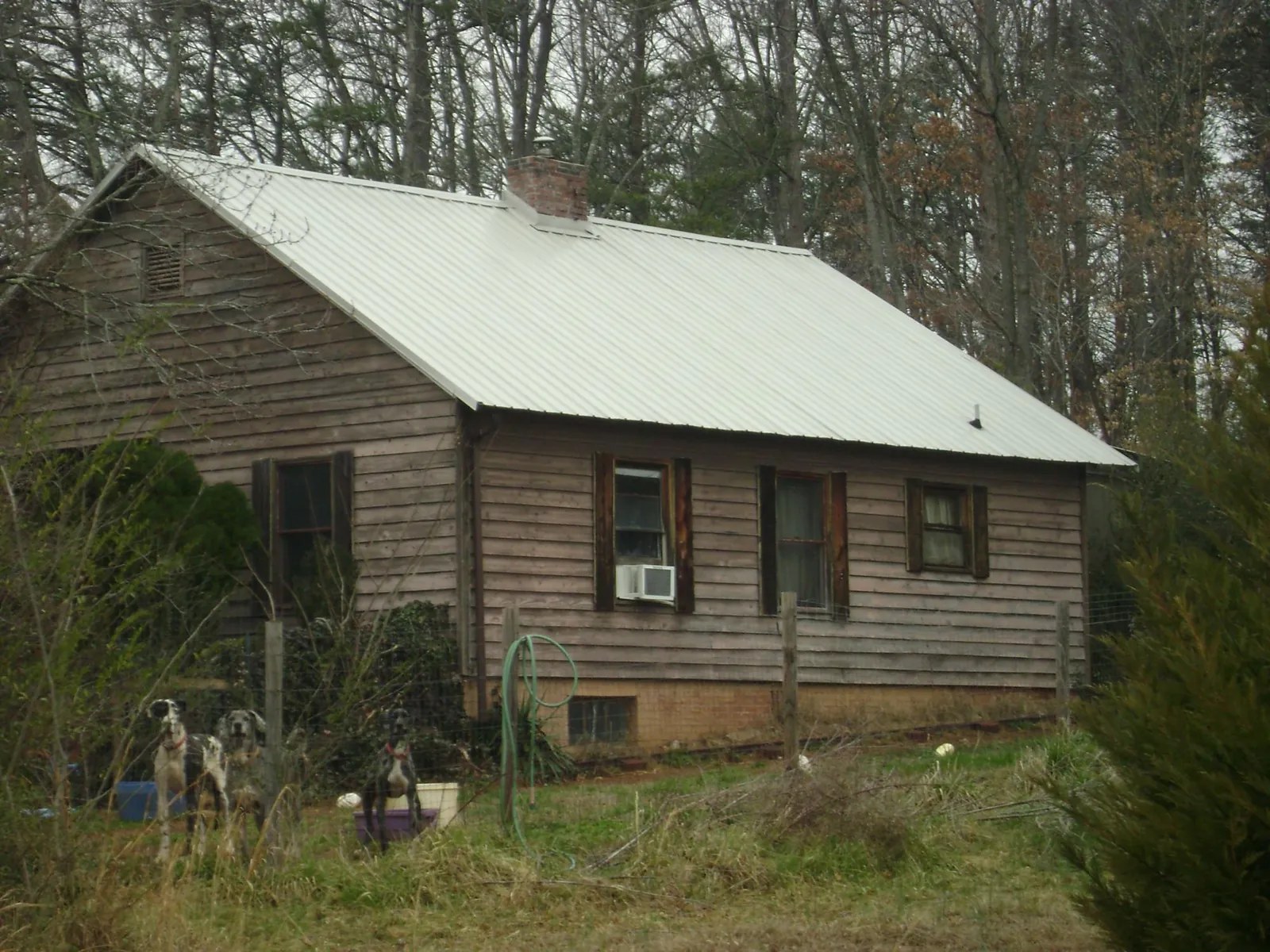 White metal roof on an old wood sided farmhouse, from a Metal Roof Installation job in Kimmswick